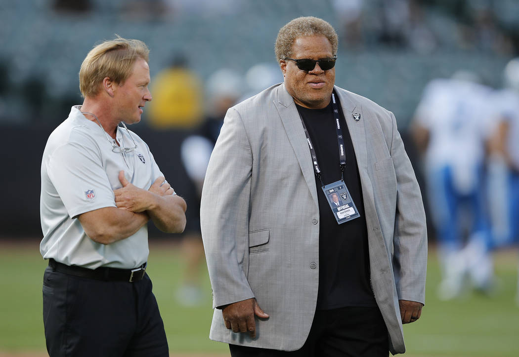 Oakland Raiders head coach Jon Gruden, left, and general manager Reggie McKenzie before an NFL preseason football game against the Detroit Lions in Oakland, Calif., Friday, Aug. 10, 2018. (AP Phot ...