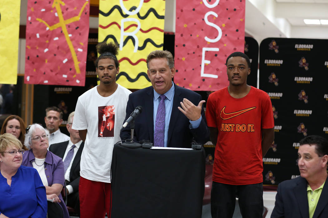 Eldorado High School Principal David Wilson speaks as Ryan Johnson, left, and Royale Davis, both Eldorado High graduates, look on during a press conference on Friday, Aug. 24, 2018, announcing a n ...