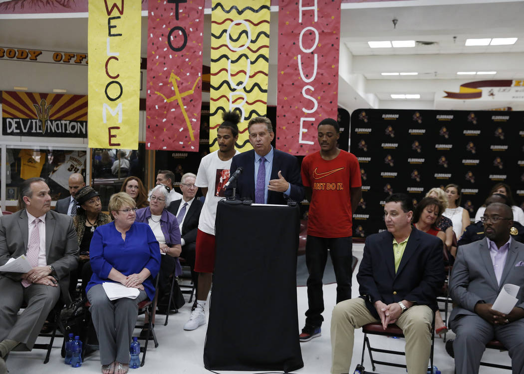 Eldorado High School Principal David Wilson speaks as Ryan Johnson, left, and Royale Davis, both Eldorado High graduates, look on during a press conference on Friday, Aug. 24, 2018, announcing a n ...