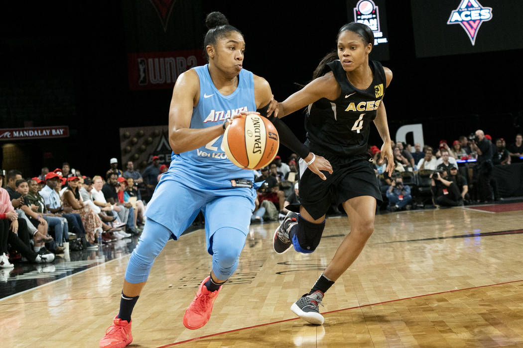 Las Vegas Aces guard Moriah Jefferson (5) tries to defend Atlanta Dream guard Alex Bentley (20) during the second half of a WNBA basketball game at the Mandalay Bay Events Center in Las Vegas, Sun ...