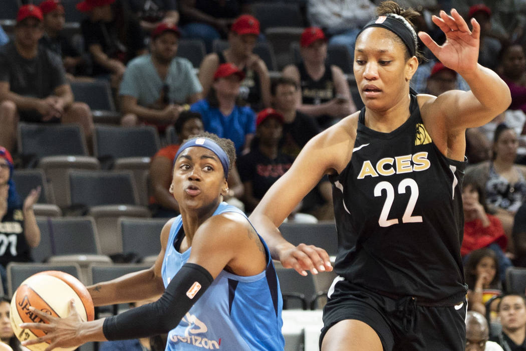 Las Vegas Aces center A'ja Wilson (22) tries to defend against Atlanta Dream shooting guard Tiffany Hayes (15) during the first half of a WNBA basketball game at the Mandalay Bay Events Center in ...