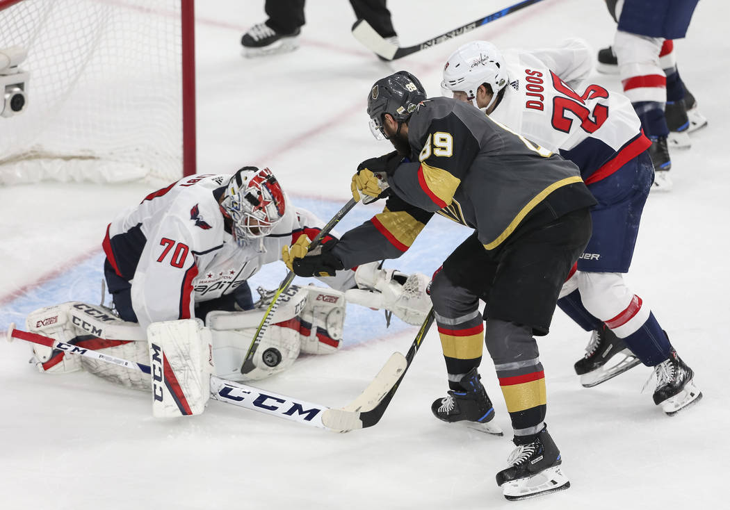 Washington Capitals goaltender Braden Holtby (70) blocks an attempt by Golden Knights right wing Alex Tuch (89) as Capitals defenseman Christian Djoos (29) defends during the third period of Game ...