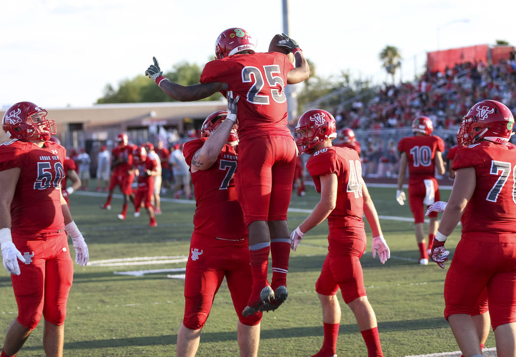 Arbor View Aggies running back Kyle Graham (25) celebrates with teammates after scoring a touchdown against the Valley View Eagles during the first half of a varsity football game at Arbor View Hi ...