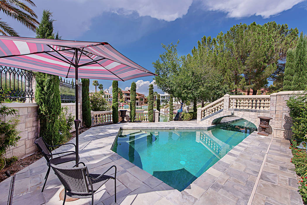 The exterior opens up to English-style gardens lined with roses. (Rob Jensen Co.)