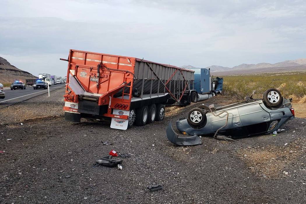The Nevada Highway Patrol investigates a fatal crash, north of Las Vegas, near Coyote Springs, Wednesday, July 18, 2018. According to the Nevada Highway Patrol, a dozing truck driver slammed into ...