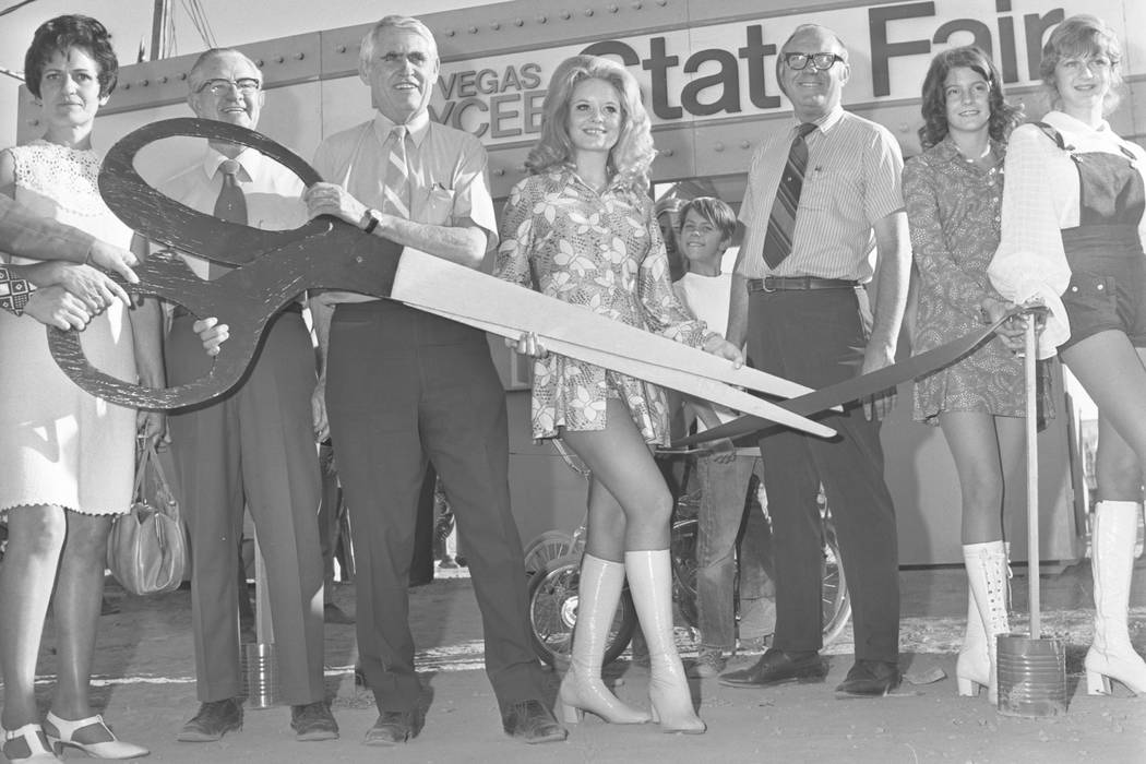 The opening of the 1971 Jaycees State Fair. This image is of Las Vegas Mayor Oran Gragson holding a giant pair of scissors during the ribbon cutting ceremony with Queen candidate Marla Carpenter a ...