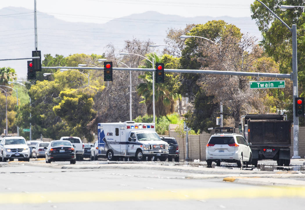 An ambulance arrives on the scene of a Metropolitan Police Department officer involved shooting near Spring Mountain Road and Rainbow Boulevard on Friday, Aug. 24, 2018, in Las Vegas. Benjamin Hag ...