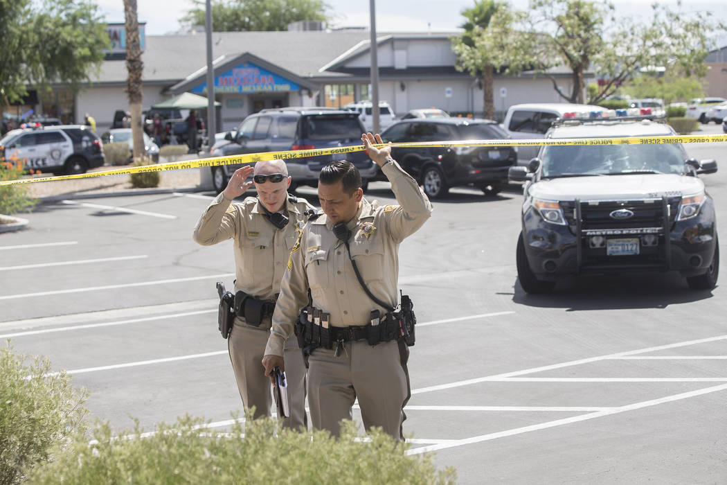 The Metropolitan Police Department investigates an officer involved shooting near Spring Mountain Road and Rainbow Boulevard on Friday, Aug. 24, 2018, in Las Vegas. Benjamin Hager Las Vegas Review ...