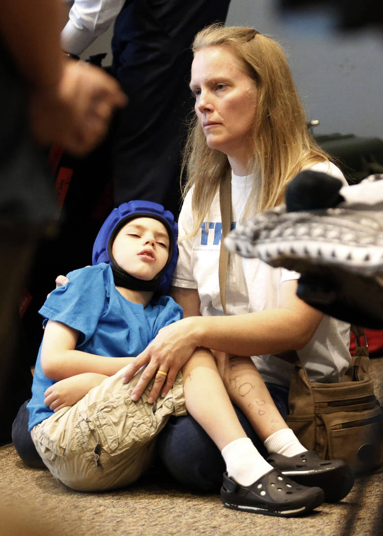 Medical-marijuana advocate Heather Nelson and her son Matthew, 10, listen during a news conference with opponents of Utah's medical marijuana ballot initiative as they lay out their case why voter ...