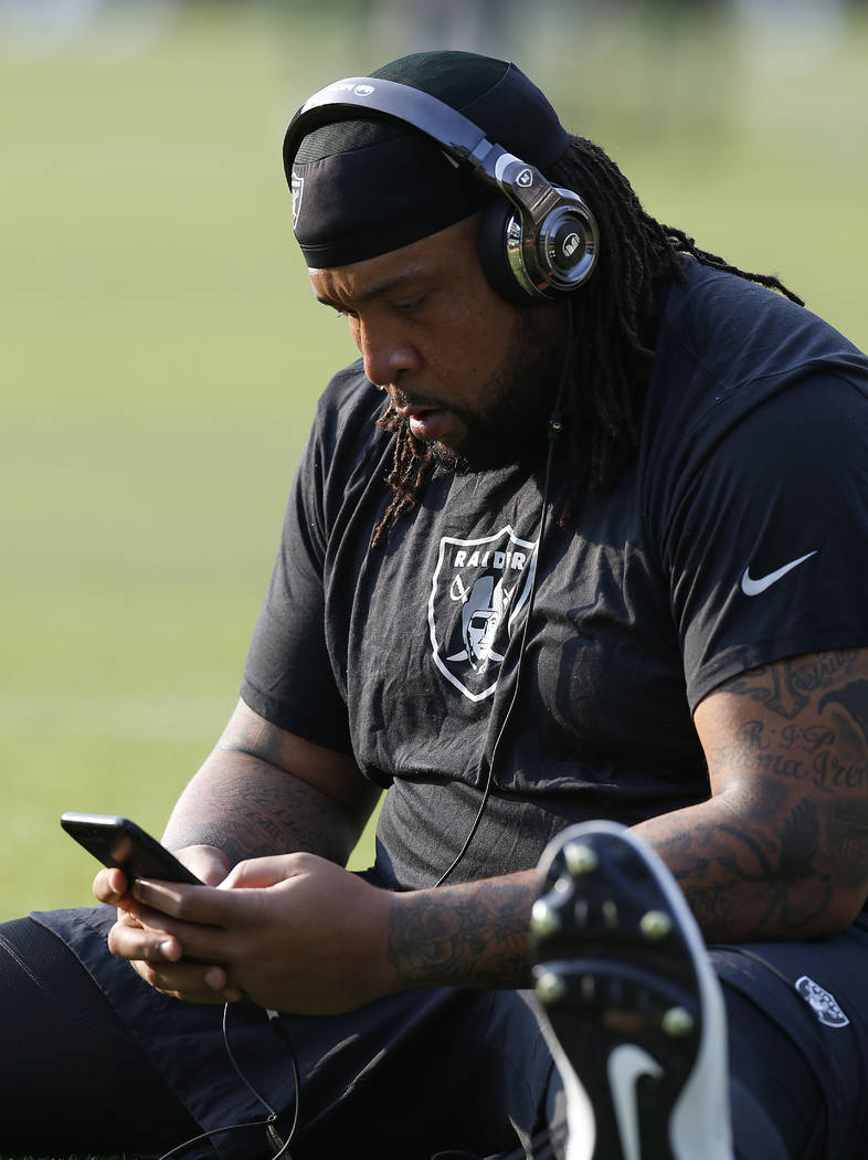 Oakland Raiders tackle Donald Penn stretches before an NFL preseason football game against the Green Bay Packers in Oakland, Calif., Friday, Aug. 24, 2018. (AP Photo/D. Ross Cameron)