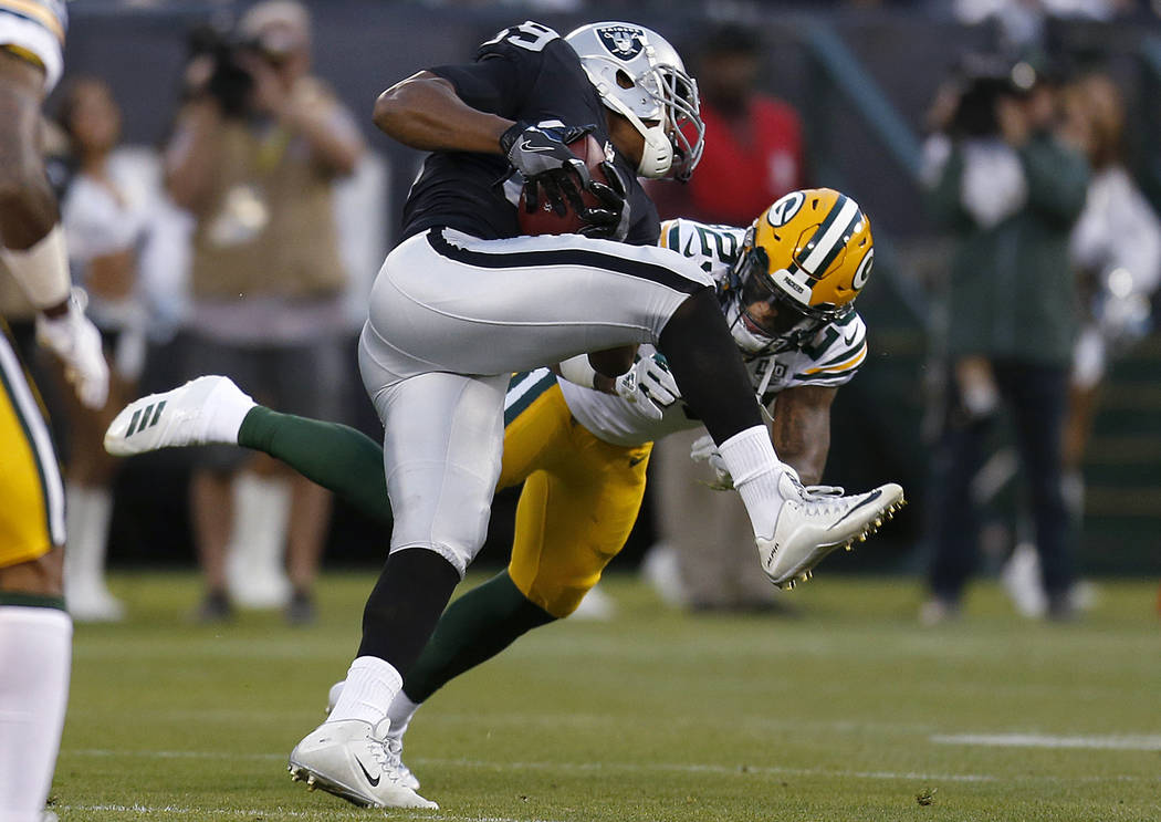 Oakland Raiders wide receiver Amari Cooper, top, runs against Green Bay Packers cornerback Jaire Alexander during the first half of an NFL preseason football game in Oakland, Calif., Friday, Aug. ...