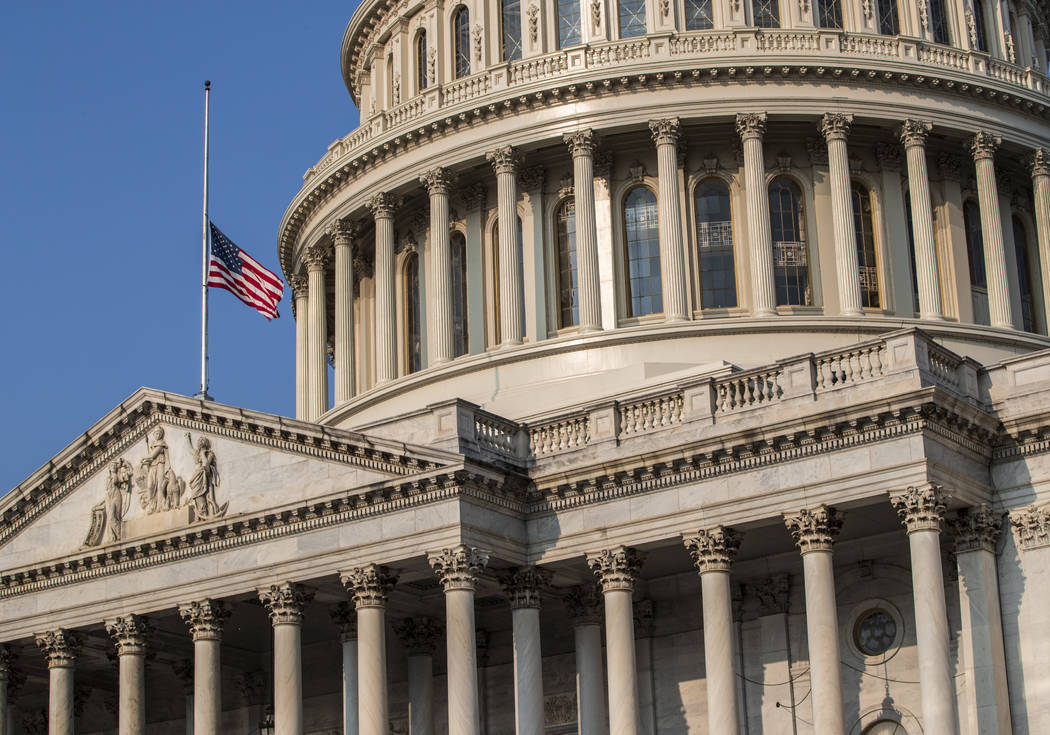 The American flag flies at half-staff at the Capitol in honor of Sen. John McCain of Arizona who died Saturday of brain cancer, in Washington, Monday, Aug. 27, 2018. McCain will lie in state in th ...