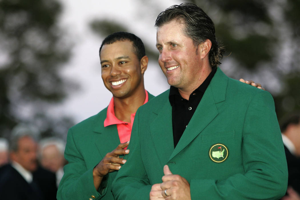 Phil Mickelson Ga. in this April 9 gets his Masters Green Jacket from last years winner Tiger Woods after winning the 2006 Masters tournament at the Augusta National Club in Augusta left 2006 Photo Picture 