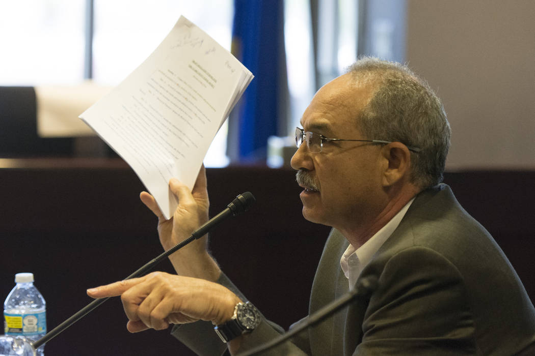 John Vellardita, executive director of the Clark County Education Association, holds up a copy of the draft regulation to reorganize the Clark County School District during a legislative panel mee ...