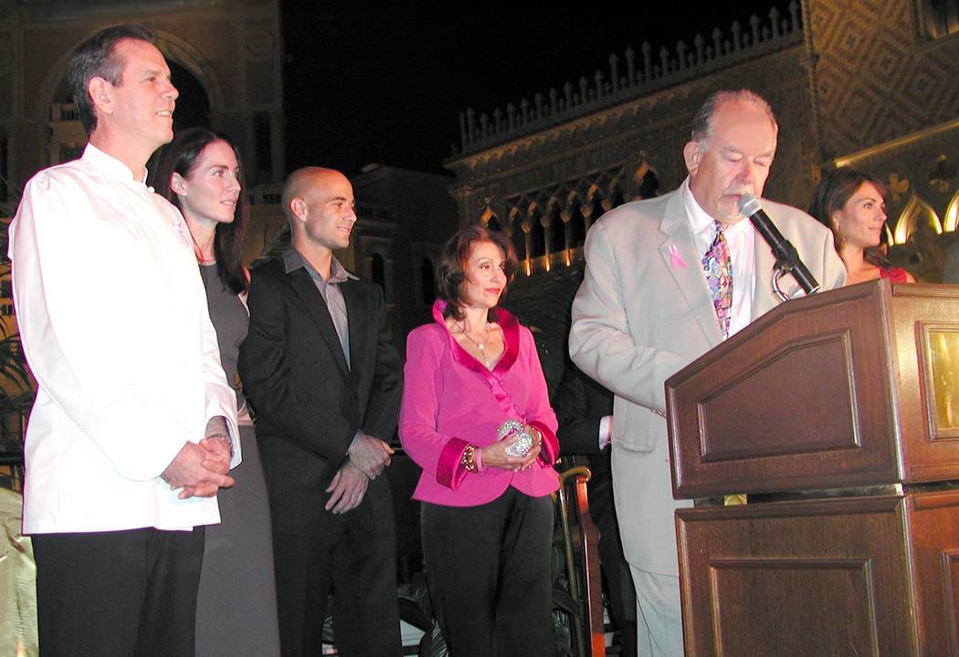 Guests gather outside The Venetian to kick off the first of several international landmarks to be illuminated in pink light to produce an awareness in the battle against breast cancer. Among the g ...