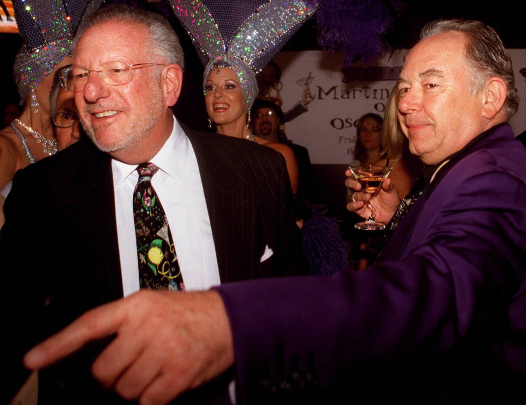Robin Leach enjoys a martini with Mayor Oscar Goodman as the mayor shakes hands with celebrities and well-wishers in 2002. (Ralph Fountain/Las Vegas Review-Journal)