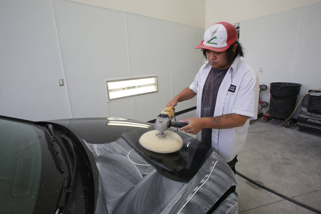 Tommy Ha of Ultimate Collision Repair Centers buffs out new paint as part of the finishing process at Ultimate Collision’s Summerlin shop on Friday, June 16, 2018. Michael Quine Las Vegas R ...