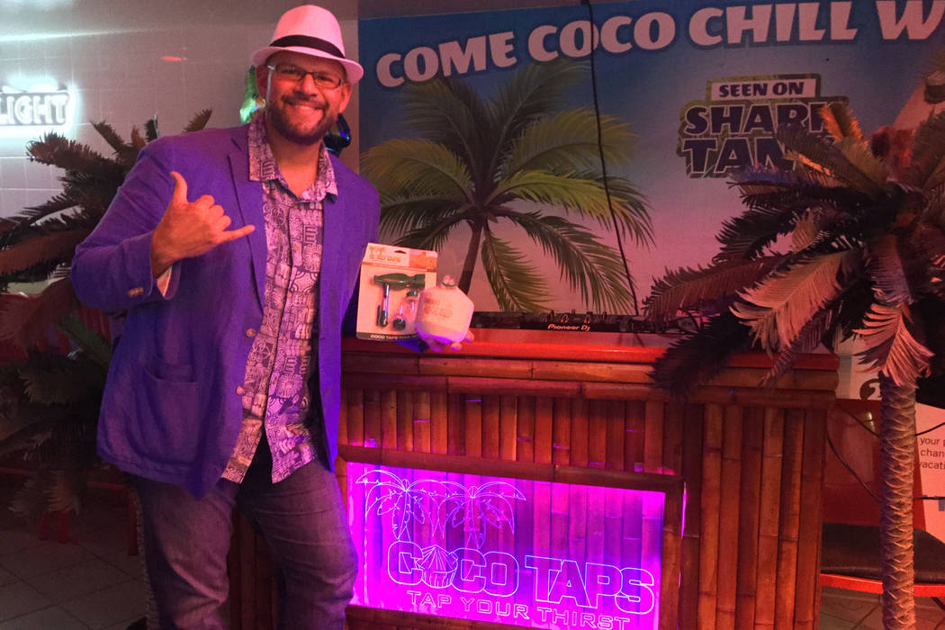 CocoVinny holds a Coco Taps toolkit and branded coconut at the Stratosphere on Aug. 7, 2018. (Bailey Schulz/Las Vegas Review-Journal)