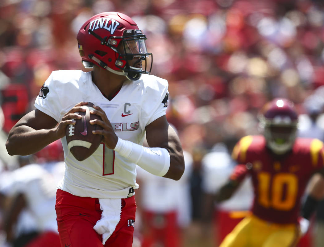 UNLV Rebels quarterback Armani Rogers (1) looks to pass during the first half of a football game against the USC Trojans at the Los Angeles Memorial Coliseum in Los Angeles on Saturday, Sept. 1, 2 ...