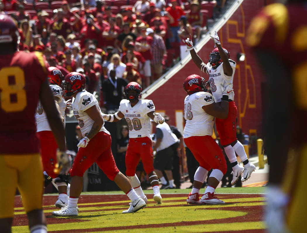 UNLV Rebels running back Lexington Thomas (3) celebrates his touchdown against the USC Trojans with UNLV Rebels offensive lineman Justin Polu (78) during the first half of a football game at the L ...