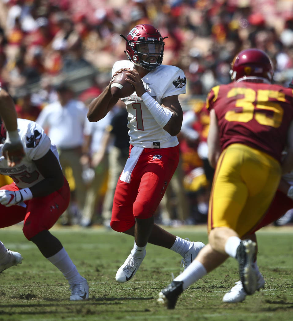 UNLV Rebels quarterback Armani Rogers (1) looks to pass during the first half of a football game against the USC Trojans at the Los Angeles Memorial Coliseum in Los Angeles on Saturday, Sept. 1, 2 ...