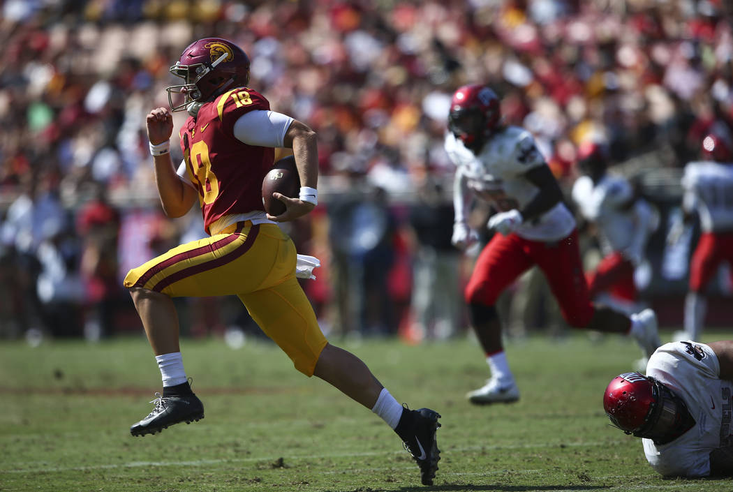 USC Trojans quarterback JT Daniels (18) runs the ball past the UNLV Rebels during the second half of a football game at the Los Angeles Memorial Coliseum in Los Angeles on Saturday, Sept. 1, 2018. ...