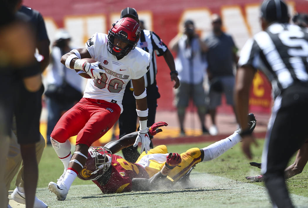 UNLV Rebels wide receiver Brandon Presley (80) is run out of bounds by USC Trojans cornerback Greg Johnson (9) during the first half of a football game at the Los Angeles Memorial Coliseum in Los ...