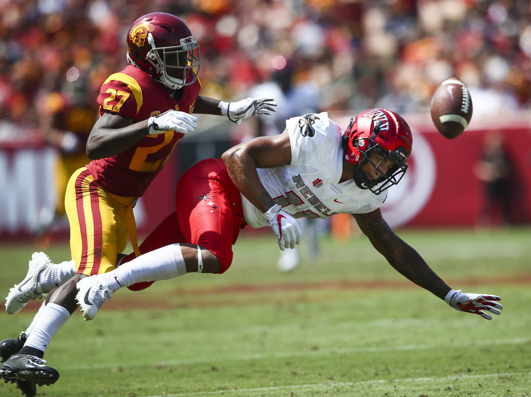 USC Trojans cornerback Ajene Harris (27) breaks up a pass intended for UNLV Rebels wide receiver Drew Tejchman (11) during the first half of a football game at the Los Angeles Memorial Coliseum in ...