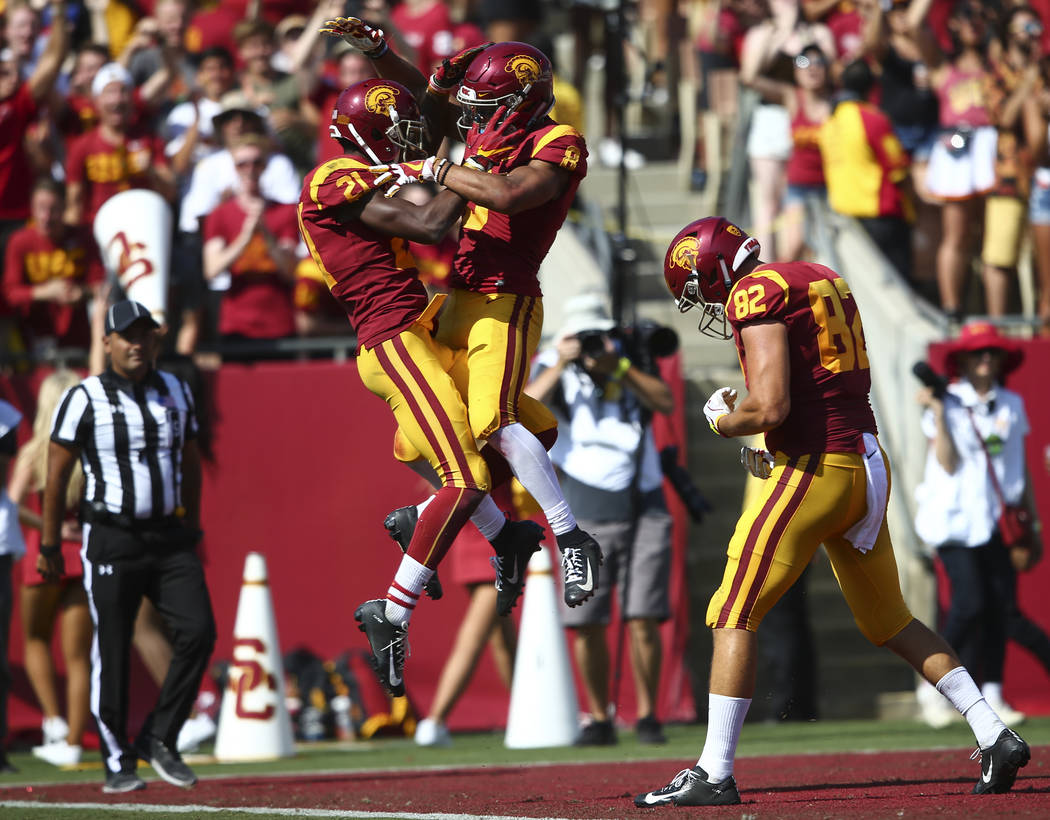 USC Trojans wide receiver Tyler Vaughns (21) celebrates a touchdown against UNLV by USC Trojans wide receiver Amon-Ra St. Brown (8) during the second half of a football game at the Los Angeles Mem ...