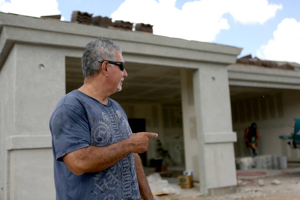 George Long, co-owner of Long’s Construction, points to one of the houses he is building on Wildflower Street in a subdivision off Hualapai Mountain Road in Kingman, Ariz. on Friday, August ...