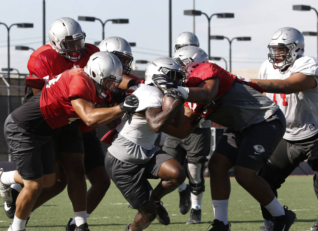 UNLV running back Charles Williams, center, is wrapped up during team practice on Wednesday, Sept. 5, 2018, in Las Vegas. (Bizuayehu Tesfaye/Las Vegas Review-Journal) @bizutesfaye