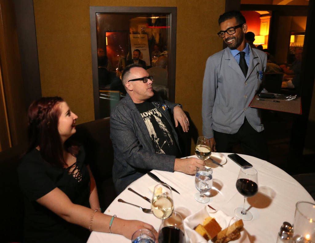 Captain server Yash Gokul visits with regular customers Madeleine Koster and Neil Fredrick at Charlie Palmer Steak at the Four Seasons in Las Vegas Tuesday, Aug. 28, 2018. K.M. Cannon Las Vegas Re ...