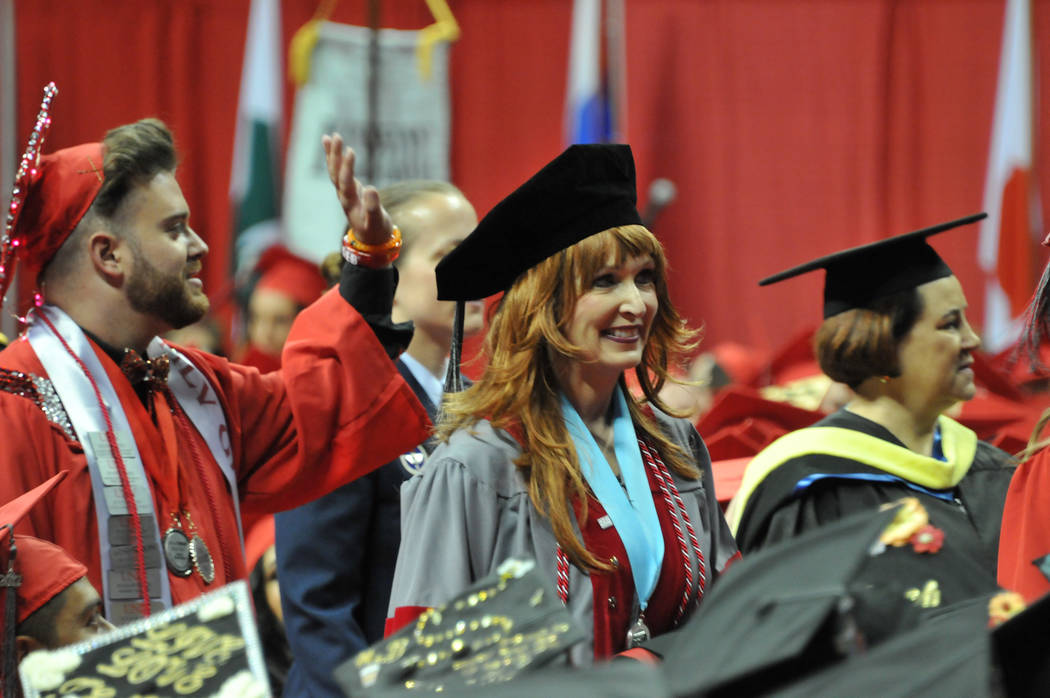 Janet King, 54, who had stage 3 lung cancer, walks to the stage May 13, 2017, at the Thomas & Mack Center to receive her doctorate at UNLV's spring commencement ceremony. (Jeff Mosier/View)