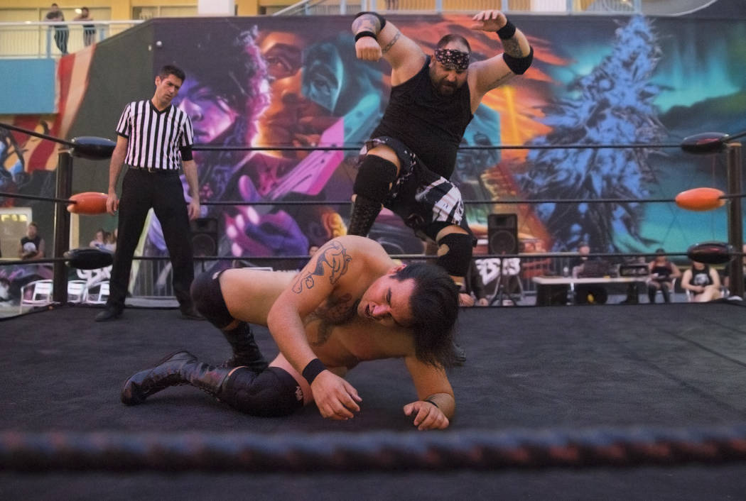 Brandon Gregory, top, aka "Death Collector Big Dirty," wrestles Tyler Seifert, aka "Tyler J. Wildhorse," during a Versus Wrestling event on Friday, Aug., 3, 2018, at Neonopolis ...