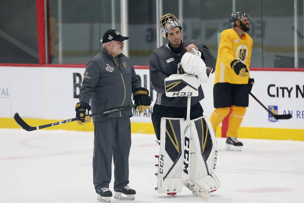 Vegas Golden Knights goaltender Marc-Andre Fleury (29), center, talks to their goaltending coach David Prior, left, during a team practice at City National Arena in Las Vegas, Wednesday, June 6, 2 ...