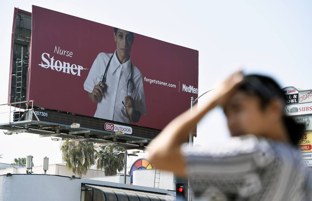 A billboard for MedMen, a marijuana dispensary, is seen at an intersection in Los Angeles in May 2018. (AP Photo/Chris Pizzello)