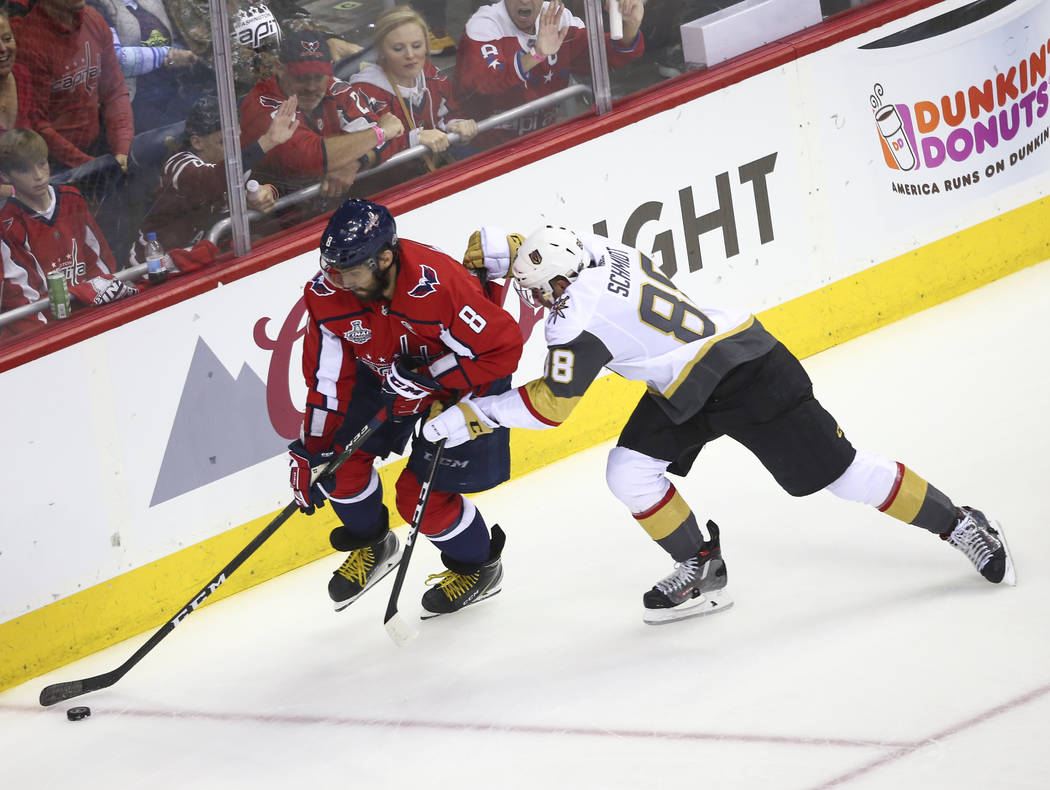 Washington Capitals left wing Alex Ovechkin (8) moves the puck as Golden Knights defenseman Nate Schmidt (88) defends during the first period of Game 3 of the NHL hockey Stanley Cup Final at Capit ...