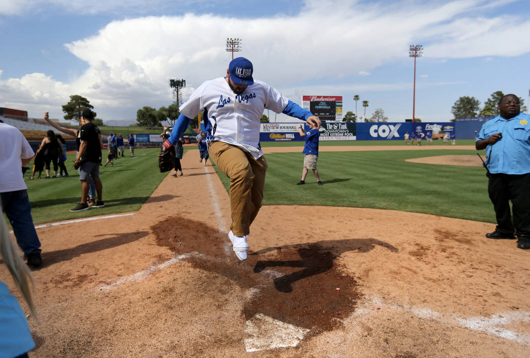 Las Vegas 51s fan Kendall Williamson jumps on home plate after running the bases after the final game ever at Cashman Field in Las Vegas Monday, Sept. 3, 2018. The team will move to a new stadium ...