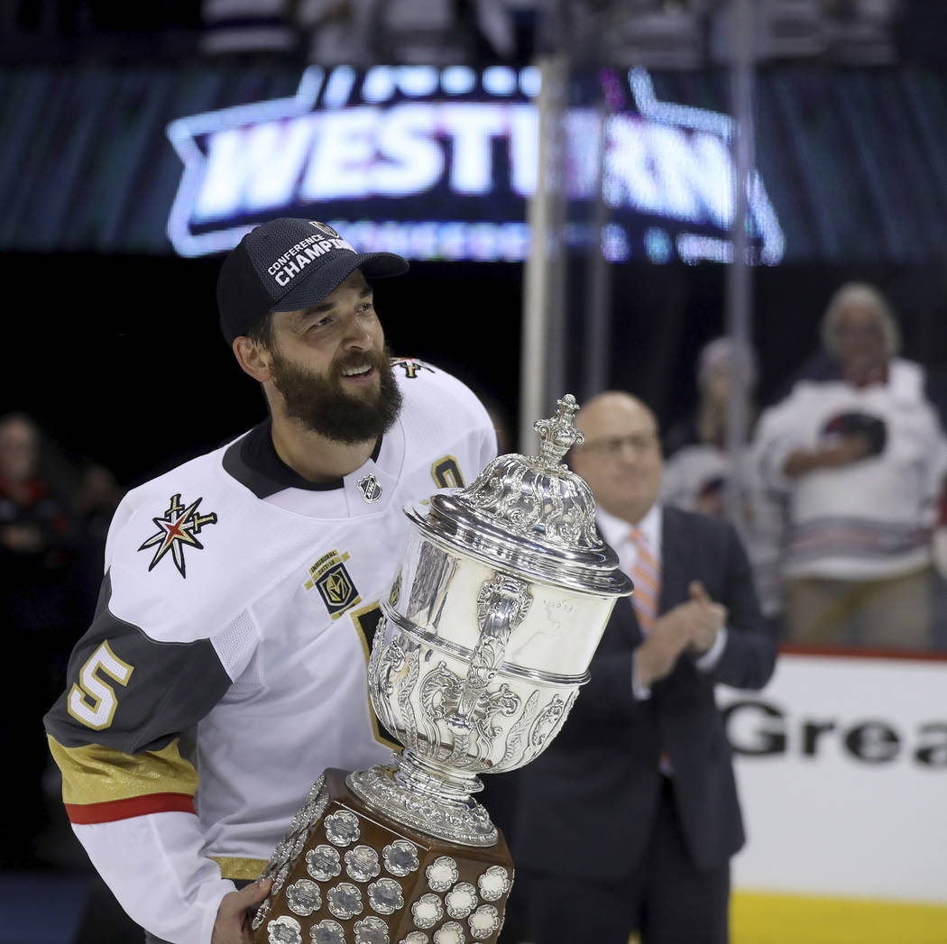 Vegas Golden Knights' Deryk Engelland (5) accepts the Clarence S. Campbell Bowl from Deputy Commissioner Bill Daly after defeating the Winnipeg Jets during Western Conference Finals, game 5, in Wi ...