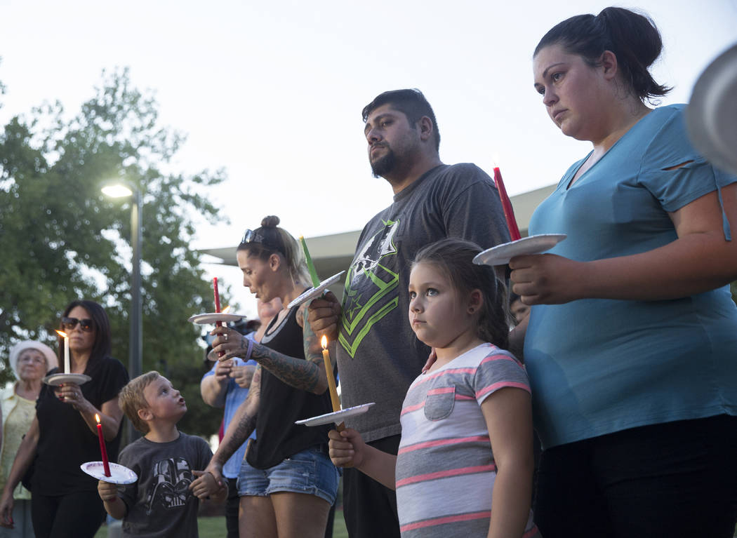 Jasmine Gonzalez, bottom/right, 5, holds a candle during a vigil for Levi Echenique, Daniel Theriot and Dejah Hunt at Sunset Park on Tuesday, Sept. 4, 2018, in Las Vegas. Benjamin Hager Las Vegas ...