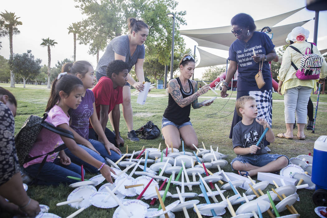 Attendees prepare candles before the start of a vigil for Levi Echenique, Daniel Theriot and Dejah Hunt at Sunset Park on Tuesday, Sept. 4, 2018, in Las Vegas. Benjamin Hager Las Vegas Review-Jour ...