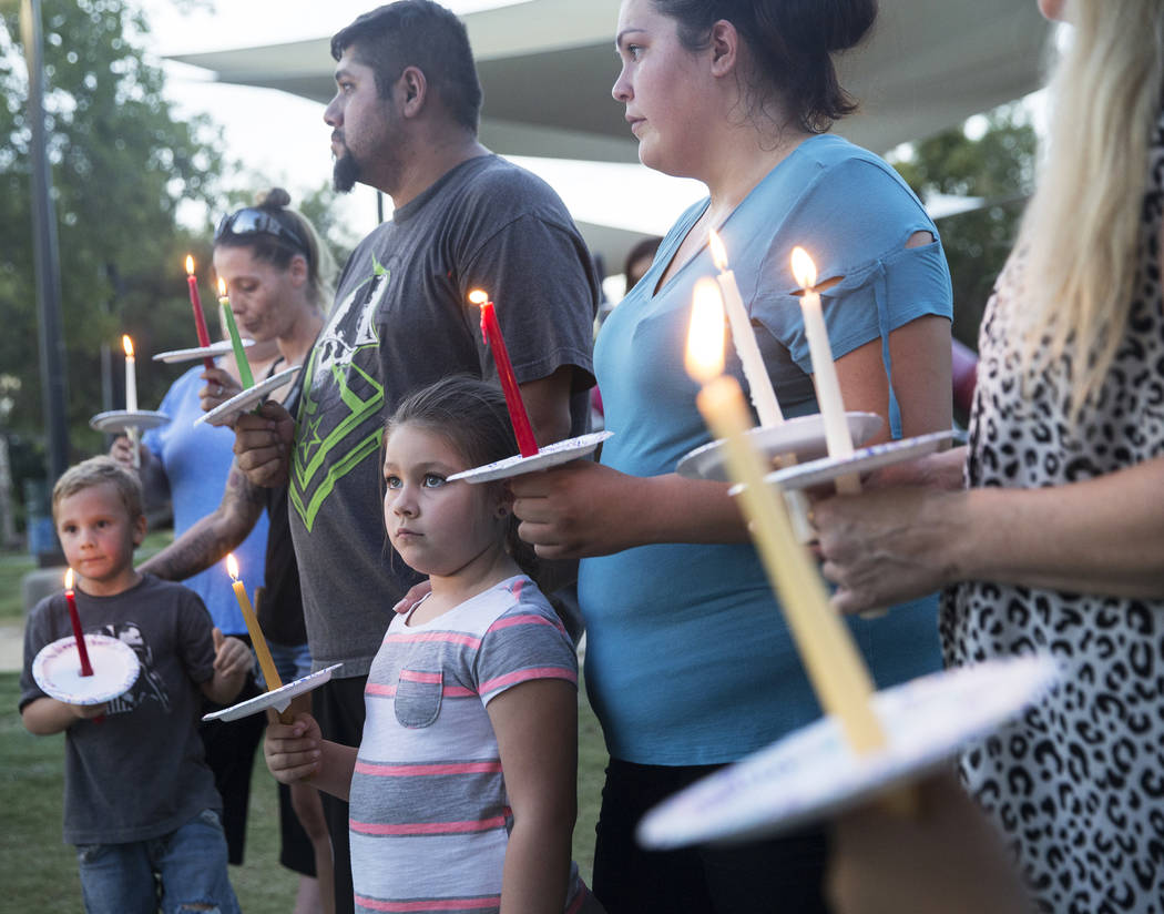 Jasmine Gonzalez, bottom/middle, 5, holds a candle during a vigil for Levi Echenique, Daniel Theriot and Dejah Hunt at Sunset Park on Tuesday, Sept. 4, 2018, in Las Vegas. Benjamin Hager Las Vegas ...