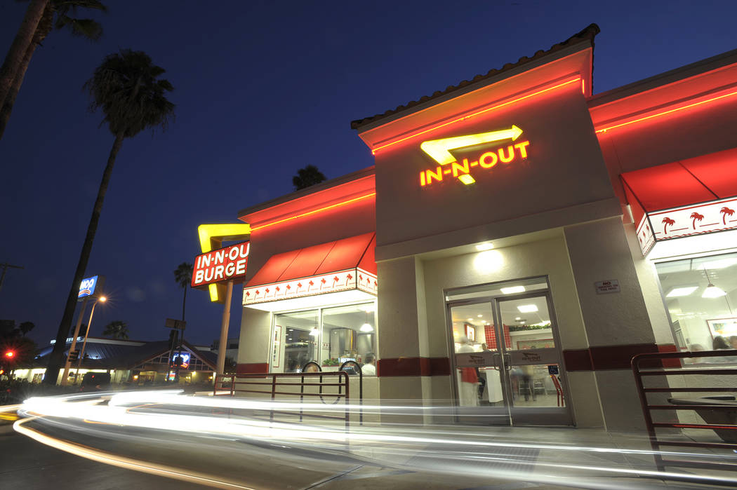 Cars exit the drive-thru at In-N-Out Burger on Friday, June 11, 2010, in the Hollywood area of Los Angeles. (AP Photo/Adam Lau)