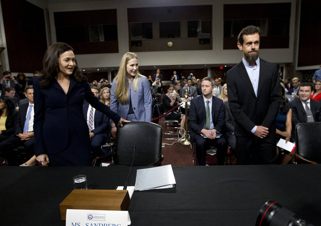 Facebook COO Sheryl Sandberg, left, accompanied byTwitter CEO Jack Dorsey arrive to the Senate Intelligence Committee hearing on 'Foreign Influence Operations and Their Use of Social Media Platfor ...