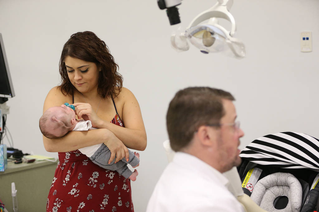 Ariale Waibel, left, mother of Blake Muschong, a 10-week-old baby with a cleft palate, during his appointment with Dr. Glen Roberson, right, an orthodontist at the Orthodontic Clinic at Roseman Un ...