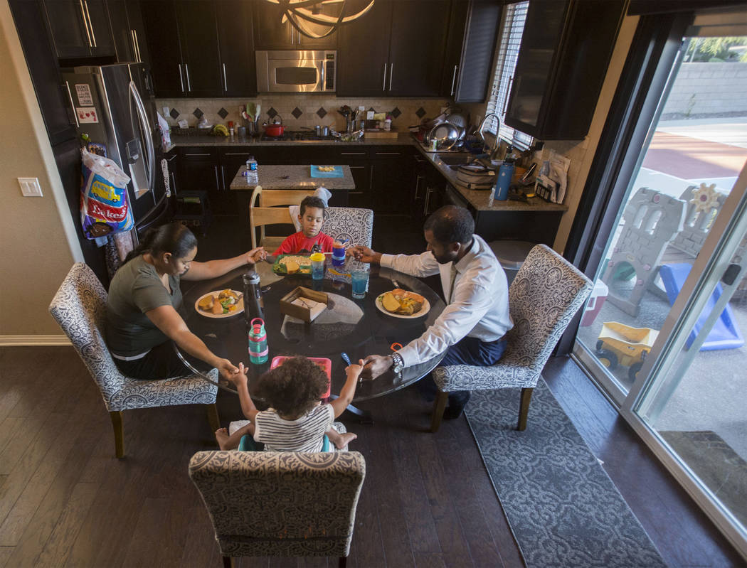 Licensed mental health therapist Sheldon Jacobs, right, prays with wife Nicole, daughter Arianna and son Jayden before his last guaranteed meal for the next 48 hours on Friday, Aug. 31, 2018, at J ...