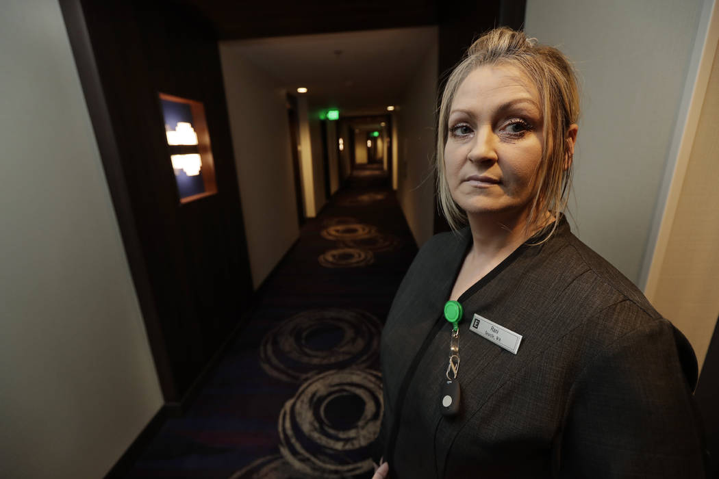 In this Wednesday, Sept. 5, 2018, photo Rani Accettola, a housekeeper at the Embassy Suites by Hilton hotel in Seattle's Pioneer Square neighborhood, poses for a photo in Seattle. Accettola is wea ...