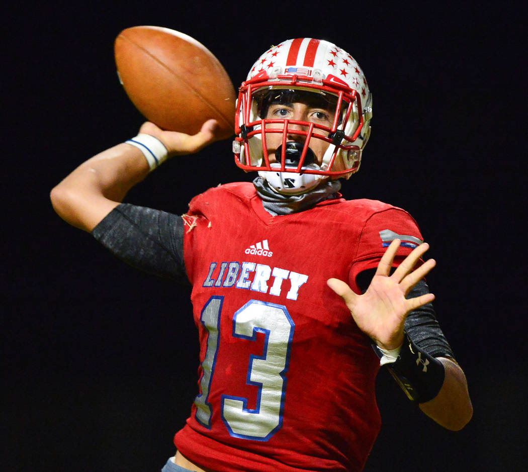 Liberty quarterback Isaac Haina (13) throws a pass during a game against IMG Academy at Liberty High School in Henderson on Friday, Sept. 7, 2018. IMG Academy leads at halftime 21-0. Brett Le Blan ...