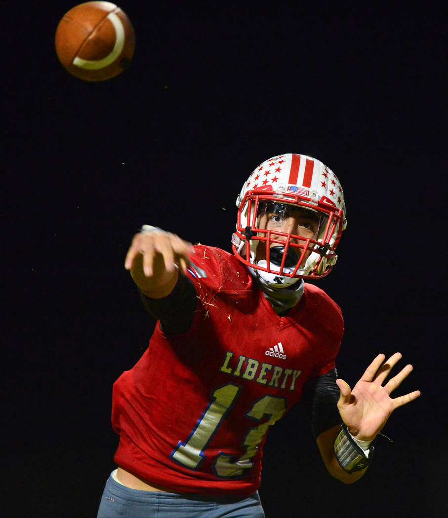 Liberty quarterback Isaac Haina (13) throws a pass during a game against IMG Academy at Liberty High School in Henderson on Friday, Sept. 7, 2018. IMG Academy leads at halftime 21-0. Brett Le Blan ...