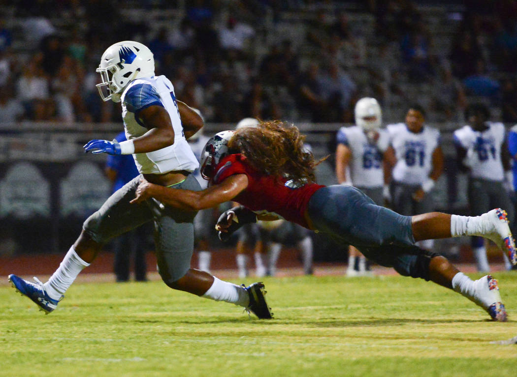 IMG Academy running back Noah Cain (7) breaks a tackle from Liberty's Zyrus Fiaseu (30) at Liberty High School in Henderson on Friday, Sept. 7, 2018. IMG Academy leads at halftime 21-0. Brett Le B ...